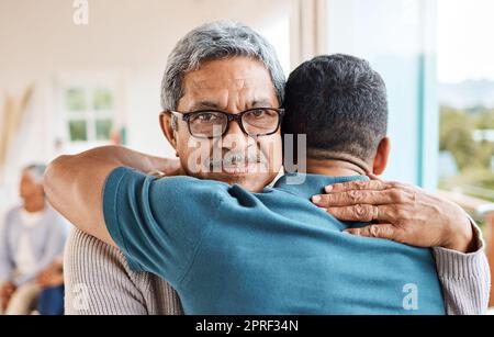 Hes never too old for a hug. a father and son hugging at home Stock Photo