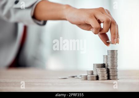 Saving, coins and growth for small business finance, stack of money for growing economy. Financial wealth and investment for profits, accounting or economics in the workplace over copy space. Stock Photo