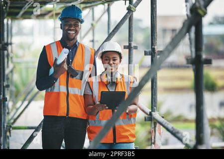 Construction, building and civil engineering team or on site workers with a tablet and plans. Portrait of contractors working as a team feeling happy and ready to engineer and build in the city Stock Photo