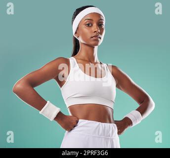 Wellness, fitness and power by a confident athletic woman serious about her health and body goals. Portrait of a gym trainer or coach with an assertive, tough, attitude and healthy lifestyle Stock Photo