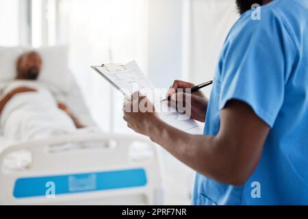 Healthcare, insurance and hospital plan by medical intern writing and filling out form. Health care professional doing admin, keep record of sick patient medication and treatment in a hospital Stock Photo