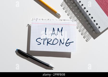 Hand writing sign I Am Strong. Concept meaning Have great strength being healthy powerful achieving everything Woman Climbing Mountain Reaching Trophy Representing Success. Stock Photo