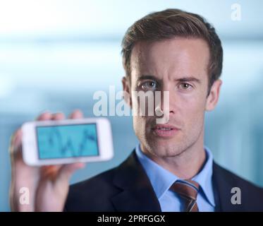 Showing you the potential for growth. A businessman showing you a graph on his smartphone Stock Photo