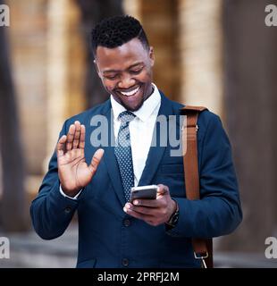 Young African businessman video call on smartphone, outside company office building and communication in city. Portrait of entrepreneur on social media, 5g internet connection with mobile technology. Stock Photo