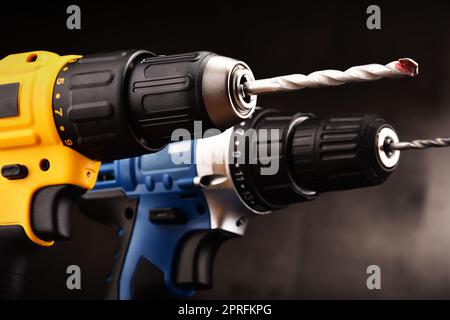 Two cordless drills with drill bits working also as screw guns. Stock Photo