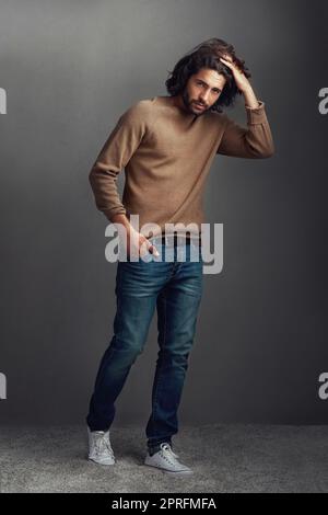 his style game is strong studio shot of a handsome young man posing against a gray background 2prfmfa