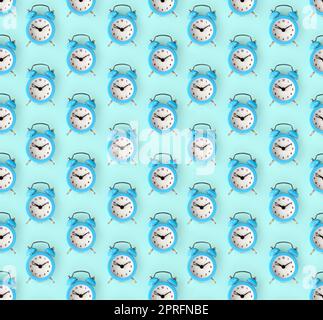 Flat lay retro beautiful new alarm clock on blue color background. Minimal pattern. Top view. Wasting time concept Stock Photo