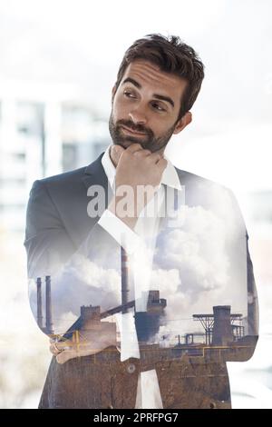 Hes well-suited for the city. a handsome young businessman superimposed on a cityscape. Stock Photo