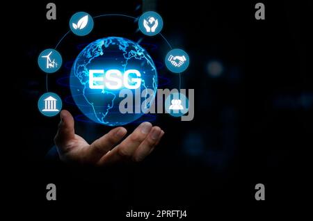 Businessman touching ESG Environmental Social Governance virtual screen Internet Business Technology Concept. Stock Photo