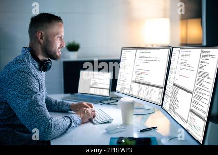 Computer Programmer Writing Program Code On Computer Stock Photo