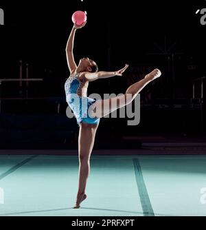 Woman dancing on floor in sport competition, training performance with ball in arena and dancer doing dance at social event or concert. Professional athlete doing gymnastics for exercise and health Stock Photo