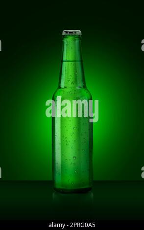 3D render. Single green beer bottle without brand designation. Full glass bottle covered with water drops against green illuminated background. Alcoho Stock Photo