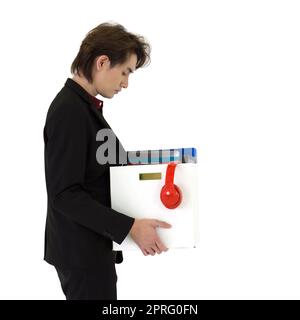 Young asian businessman in black suit feel sad, stressed and unhappy face holding paper box of belongings collected from office in the get fired day. Idea for unemployed person, work crisis. Side View Stock Photo