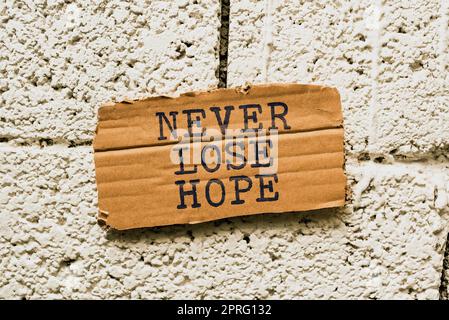 Conceptual caption Never Lose Hope. Business concept Be positive optimistic have motivation to keep going Stock Photo