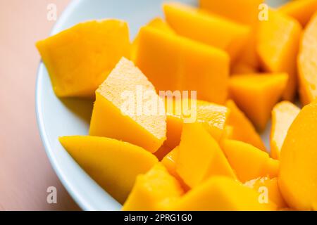 Diced fresh mango fruit on plate Stock Photo