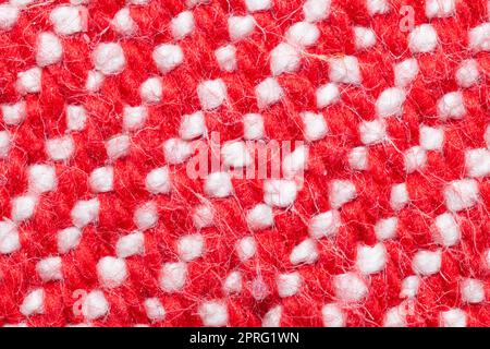 Handmade knitted fabric. red and white woolen background Stock Photo