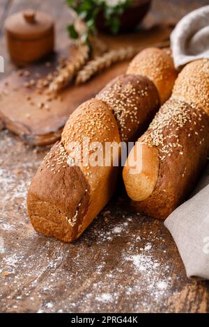 Close up of multigrain buns on wooden table in rustic style. Stock Photo