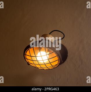 A spotlight-like lamp attached to a house wall. Stock Photo
