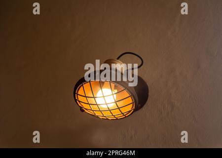 A spotlight-like lamp attached to a house wall. Stock Photo