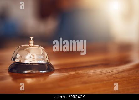 Service bell at information desk at a hotel, motel or restaurant for hospitality industry background. Customer service or help at receptionist in a luxury suite for tourism business Stock Photo