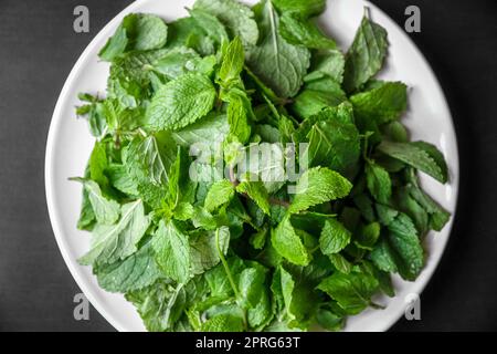 Fresh mint leaves on a plate Stock Photo