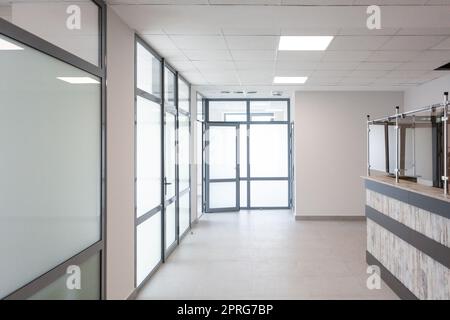 Stylish minimalist office corridor with empty receptions in modern coworking center. Stock Photo