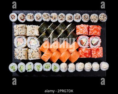 Philadelphia roll, california, unagi, black dragon with fresh ingredients on black background. Stock Photo