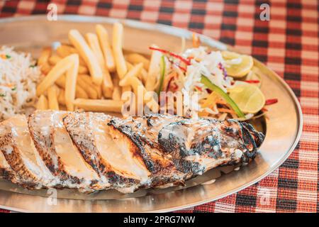 Goa, India. Fried European Bass With Potatoes And Salad On Dish Stock Photo