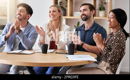 Diversity, audience and creative workers clapping hands for a celebration, growth and good news in a startup company. Motivation, teamwork and thank you applause for target or goal achievement Stock Photo