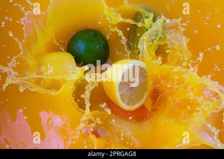 orange juice fruit slashing liquid drops lime lemon flavor healthy fresh drink Stock Photo