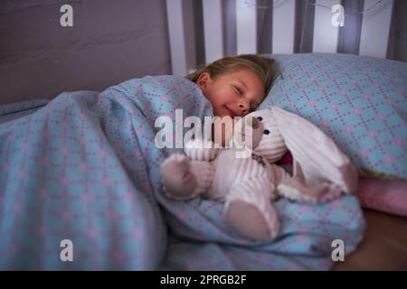 Next stop, dreamland. a little girl sleeping in bed with her teddy bear. Stock Photo