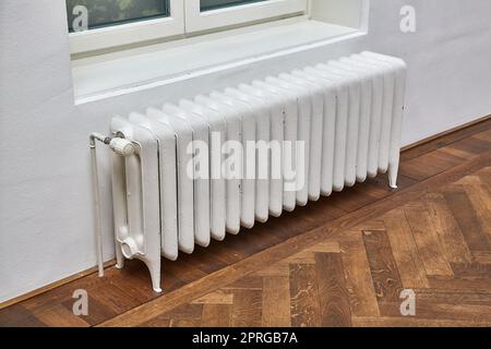 Heating radiator in an indoor space Stock Photo