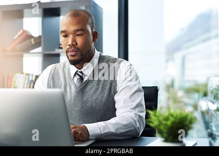 Focused on success. a young businessman working on his laptop in the office. Stock Photo