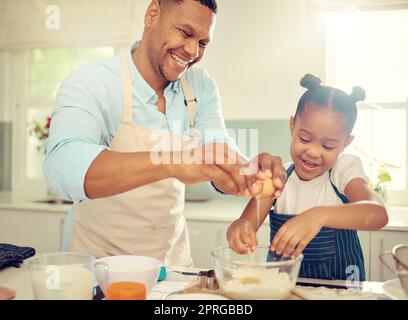 Father, learning girl or baking in home kitchen and cooking a children cake, dessert or breakfast cookies. Fun, happy and comic child with smile in house with bonding family man with health food egg Stock Photo