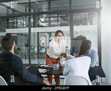 Its great to finally have you on board. two businesswomen shaking hands during a meeting. Stock Photo