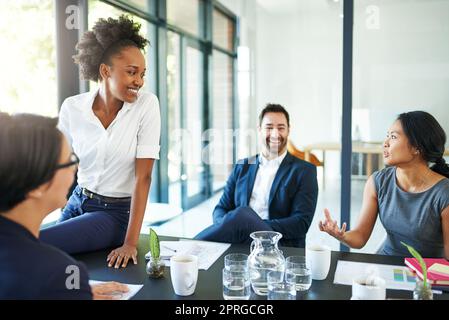 Everyones positive about progress. a group of colleagues meeting in the boardroom. Stock Photo