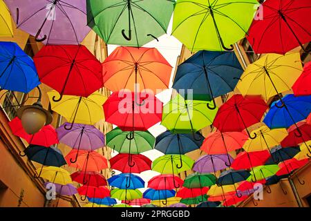 Colored umbrellas hanging at the top. Local landmark. Bold colors Stock Photo
