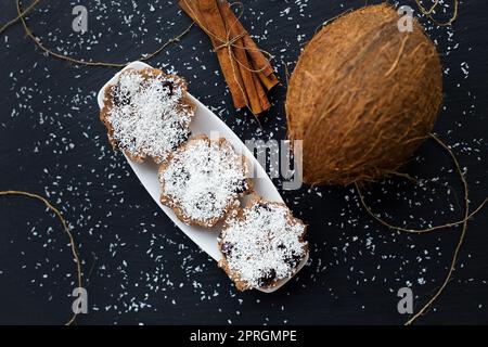 coconut muffins with chocolate on a black background and whole coconut Stock Photo