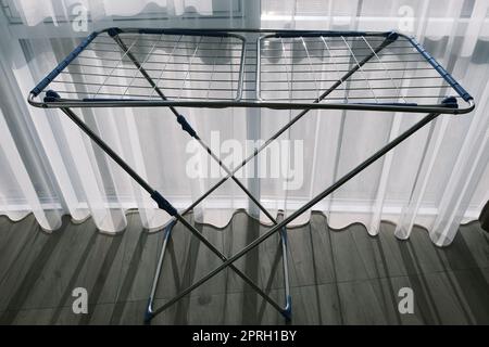 Clothes Dryer Metal Rack Laundry Home near window Stock Photo
