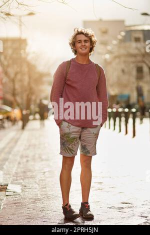 Im a city boy at heart. Portrait of a young man standing in a city street. Stock Photo