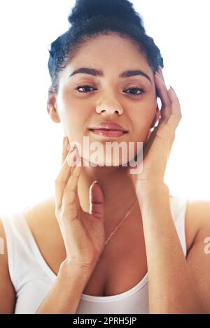 Fabulous skin feels so amazing. Portrait of a young woman feeling her soft skin. Stock Photo