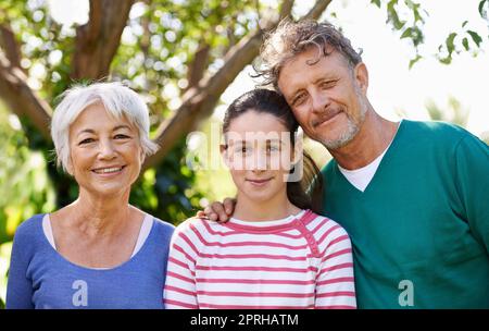 Shes her grandparents treasure. grandparents and a young granddaughter Stock Photo
