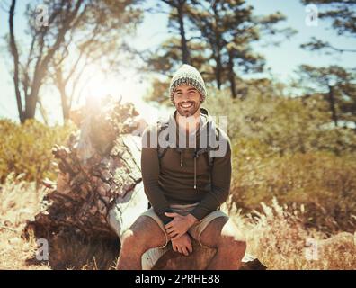 I love being out here. Cropped portrait of a young man taking a break while hiking. Stock Photo