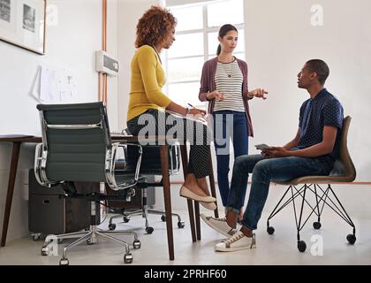 Planning turns ideas into profit. a group of colleagues having an informal meeting in a modern office. Stock Photo