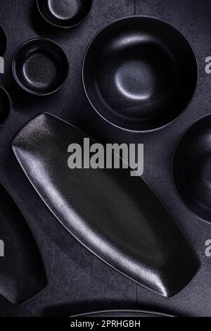 black plates and bowls on a black background Stock Photo