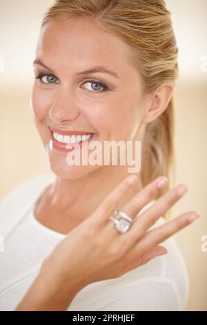He finally popped the question. Portrait of an attractive young woman showing off her engagement ring Stock Photo