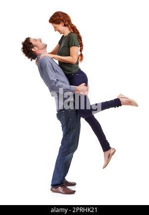 Love makes them feel alive. Full-length studio shot of a handsome man lifting up his girlfriend Stock Photo