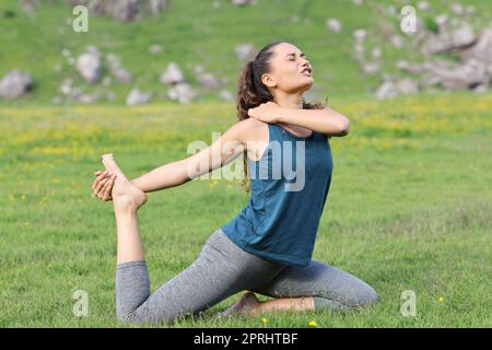 Yogi suffering accident in shoulder complaining while is doing yoga exercise Stock Photo