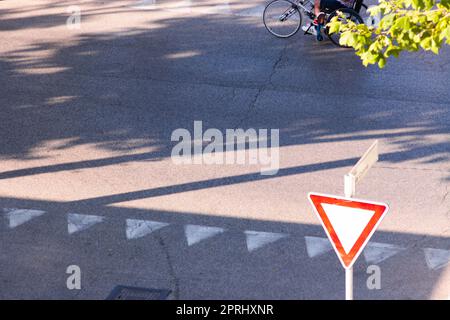 Traffic signs to stop, on a post and on the floor. Rimini, Italy Stock Photo
