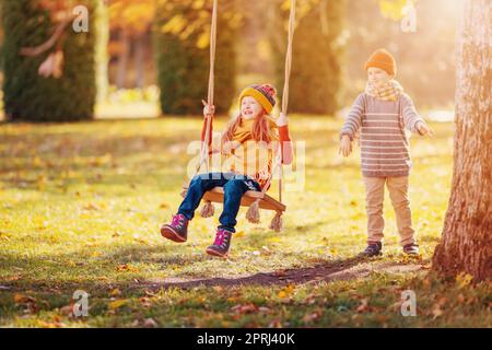 Couple of children playing in the autumnal park. Stock Photo